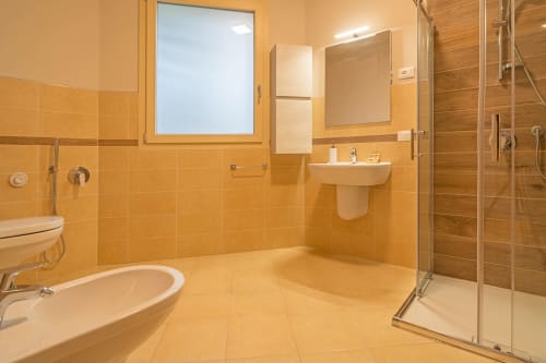 Spazioso bagno moderno a Le Alpi bed & living con pareti rivestite in piastrelle arancioni, doccia walk-in e doppio lavabo in montagna