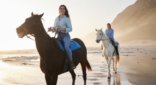 Dos mujeres cabalgando en la playa de Zahara al atardecer, Hotel Boutique Zahara