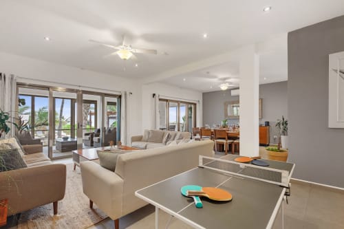 Modern villa living room with ping pong table, sea views, and beachfront access in Isla Mujeres