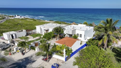 Villa Seven at Isla Mujeres Realty with ocean view, white architecture, pool, and Caribbean sea backdrop
