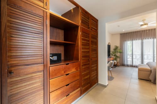 Wooden wardrobe with drawers and safe in Villa Seven, Isla Mujeres hotel room with sea view access