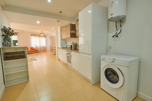 Modern kitchen and laundry area in Mendez Nuñez Sunny Flat apartment, Castelló de la Plana, with white appliances and