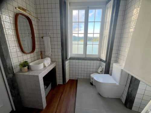 Modern bathroom in Casa Dos Barcos cottage overlooking Furnas lake, São Miguel, with white tile walls, vessel sink, toilet,