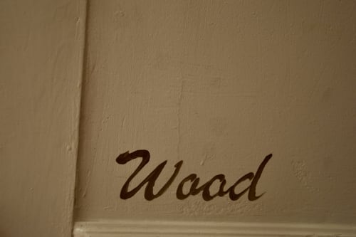 Wood room detail with cursive 'Wood' text at I colori della Sicilia B&B, Caltagirone, Sicily