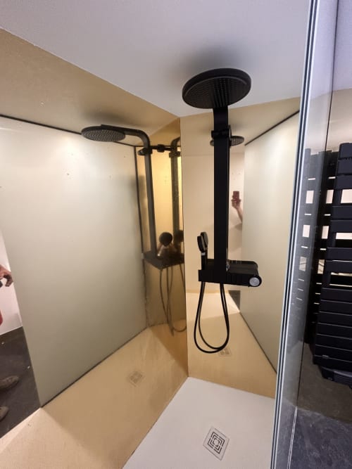 Modern black rainfall showerhead and handheld spray in contemporary shower enclosure at Gîte Les Oliviers d'Ardèche cottage,