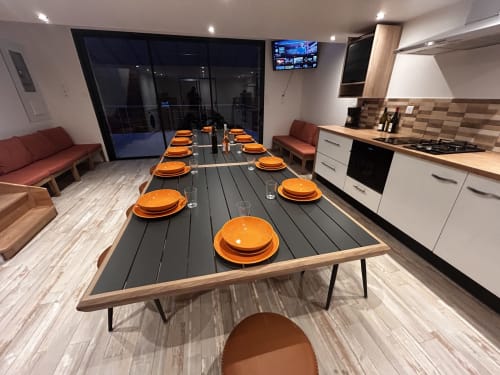 Modern cottage dining area with orange place settings, kitchen, and mountain views at Domaine du Chambonnet, Ardèche