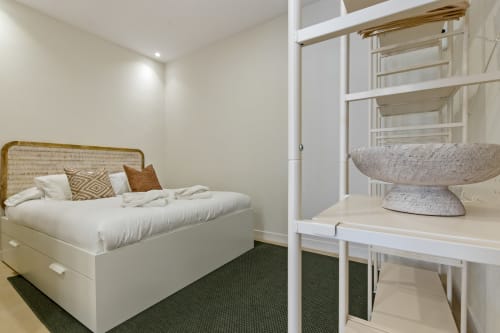 Modern bedroom suite at Ayma Properties with queen bed, bunk beds, and contemporary furnishings in Alhaurín de la Torre