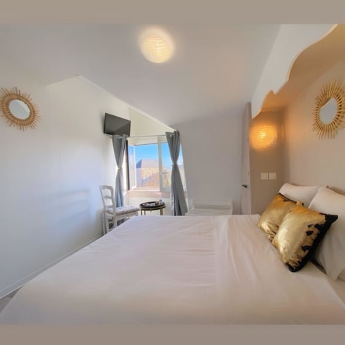 Chambre twin à l'Hôtel le Vauban, Carentan : lits aux draps blancs, oreillers dorés, vue fenêtre et équipements modernes