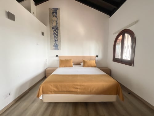 Quarto moderno em Monte Horeb Nadadouro com vista para o lago, cama de madeira com manta dourada, paredes brancas minimalistas e
