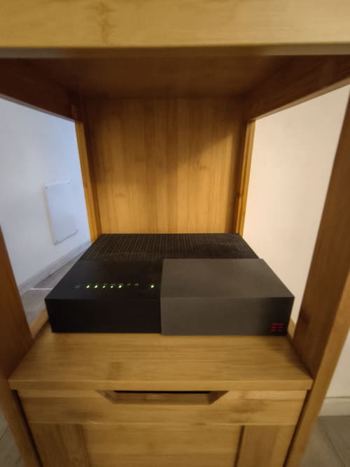 Wooden desk with router and modem in Alfredo's House apartment in Siena, Italy