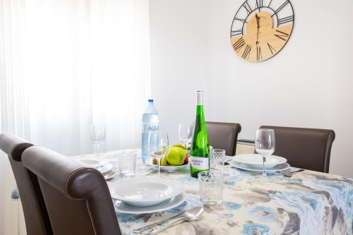 Elegant dining table setup at Haus Holiday Homes apartment in Los Alcázares with wine, water, and place settings