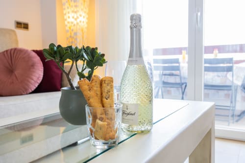 Prosecco bottle with appetizers in Los Alcázares apartment, elegant sea view setting