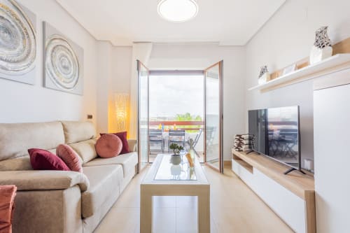 Modern apartment living room at Haus Holiday Homes, Los Alcázares, with sea view balcony and contemporary furnishings