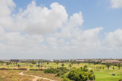 Golf course and palm trees view from Haus Holiday Homes apartment in Los Alcázares, Spain