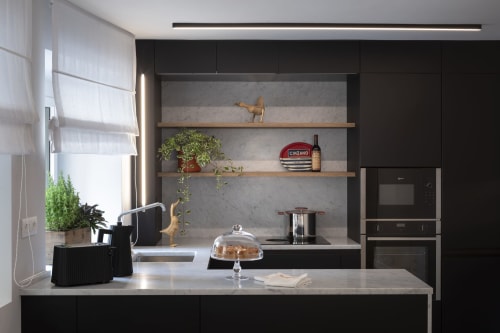 Modern kitchen at Camere d'Aria BnB in Locana with black cabinetry, marble accents, and wooden shelving