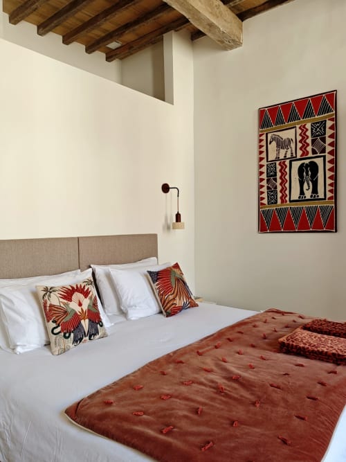 Olympe bedroom at Le Rêve d'Alice, Saint-Puy with beige headboard, white linens, red African-inspired throw, decorative