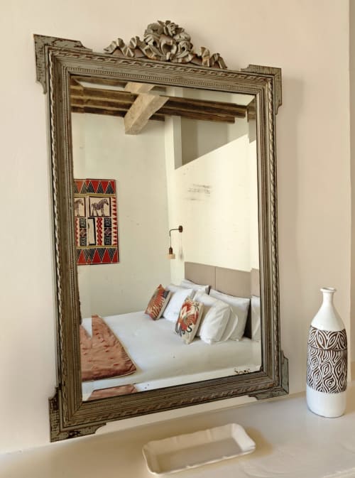 Ornate mirror reflecting bedroom at Le Rêve d'Alice B&B in Saint-Puy, France