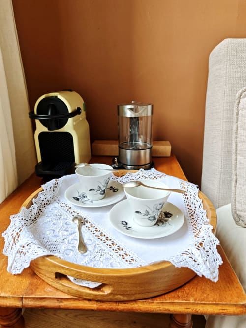 Coffee service set in Olympe room at Le Rêve d'Alice B&B, Saint-Puy, with espresso machine, cups, and white doilies