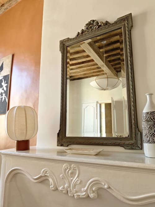 Ornate mirror above fireplace mantel in Olympe room at Le Rêve d'Alice B&B, Saint-Puy with decorative accessories
