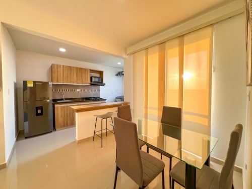 Cocina y comedor moderno en Olamar Living de Coveñas con electrodomésticos de acero inoxidable y vistas al océano