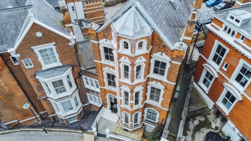 Aerial view of Stay at Wellington Circus, a red brick Victorian apartment building in Nottingham with white trim and ornate