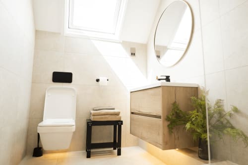 Modern bathroom in The Oriel Loft at Stay at Wellington Circus, Nottingham, featuring white toilet, wooden vanity, round
