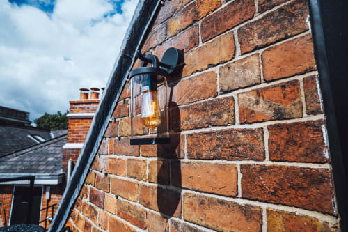 Victorian brick wall with black lantern light fixture at Wellington Circus hotel in Nottingham