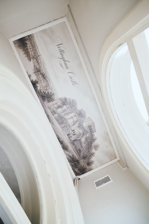 Framed sketch of Wellington Circus building with elegant cursive text on white ceiling in The Oriel Loft, Nottingham