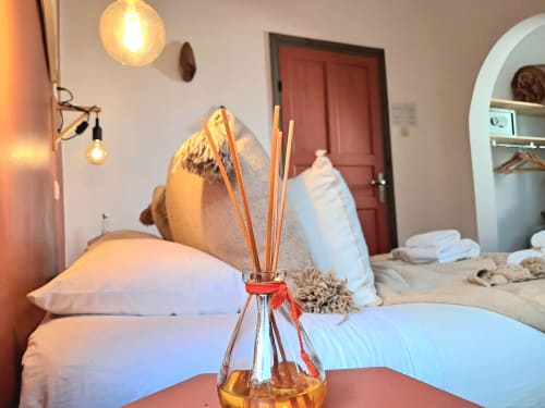 Vent Des Dunes hotel room in Essaouira with reed diffuser, pillows, and warm lighting