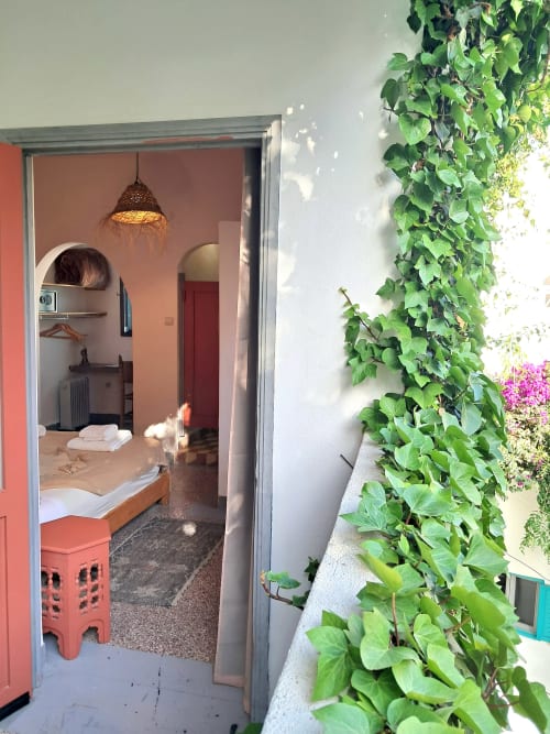 Hotel bedroom entrance with olive tree ivy on balcony at Vent Des Dunes, Essaouira