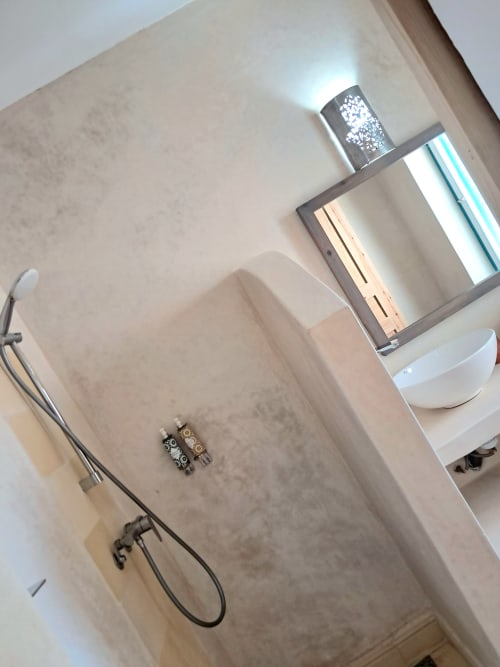 Luxury bathroom at Vent Des Dunes & Spa in Essaouira featuring modern fixtures, marble walls, and double vanity sink