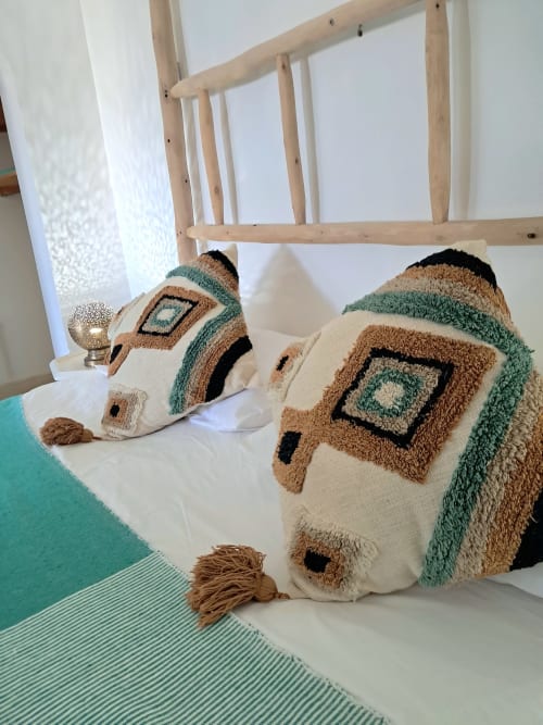 Decorative woven poufs with geometric patterns in cream, tan, and sage green at Vent Des Dunes & Spa, Essaouira