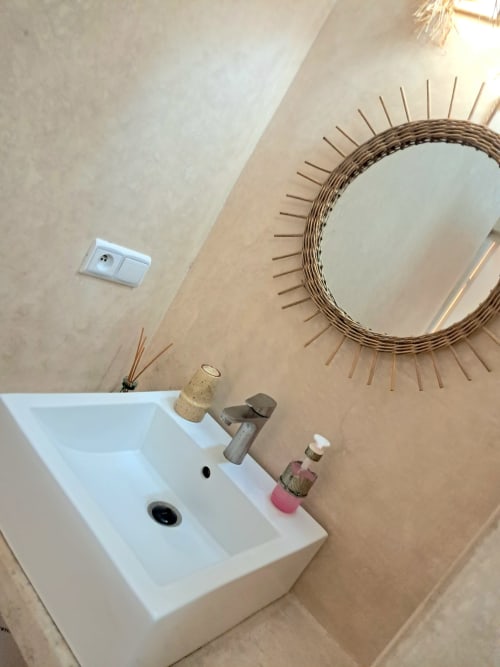 Modern bathroom sink with decorative mirror at Vent Des Dunes & Spa hotel in Essaouira