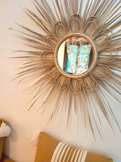 Decorative woven sunburst mirror on cream wall at Vent Des Dunes & Spa, Essaouira