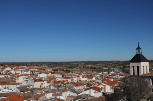 Vista aérea de Colmenar de Oreja con edificios blancos y terracota, campanario y ubicación de Casa Rural La Herrería