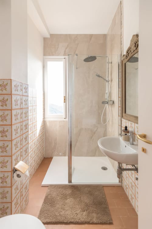 Salle de bains moderne de l'hôtel Allegria, Bajardo, avec douche à l'italienne, lavabo sur colonne, carrelage en terre cuite et vue sur les montagnes
