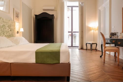 King Superior room at Casa Beretti B&B in Catania with bed, balcony, wooden floors, and modern amenities.