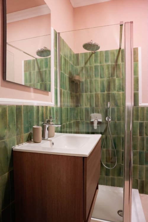 Modern bathroom at Casa Beretti Catania with green tile shower, wood vanity, mirror, and rainfall showerhead in King Superior