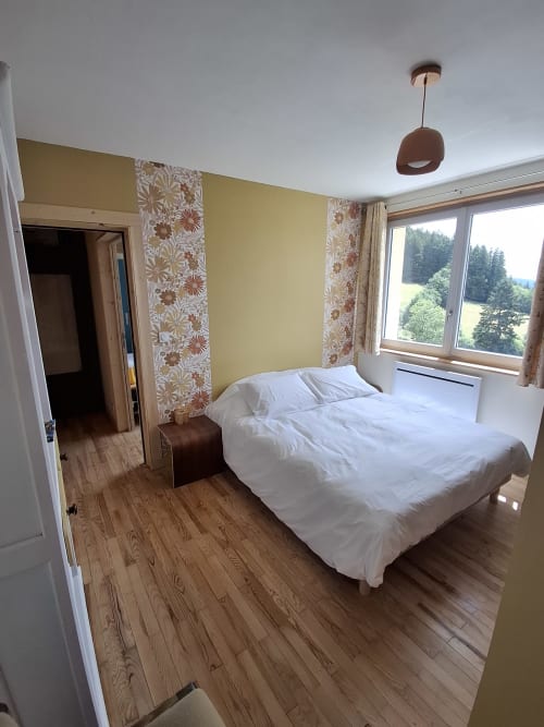 Chambre Passiflore at La Maison de Dun B&B in Saint Racho with mountain views, yellow walls, and wood flooring