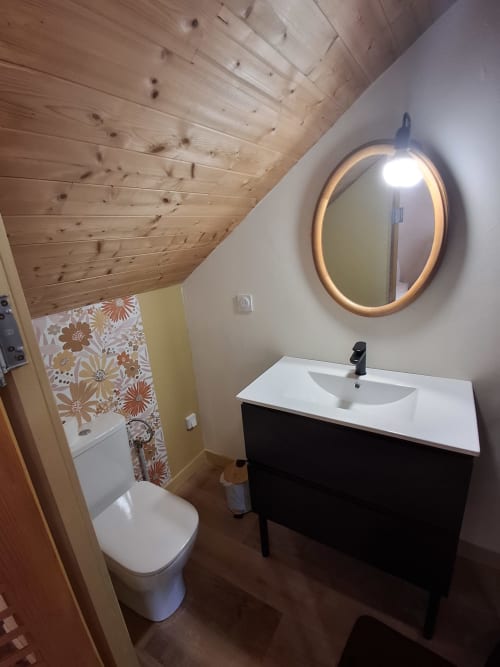 Modern bathroom in Chambre Passiflore at La Maison de Dun B&B, Saint Racho, with illuminated oval mirror, black vanity, white