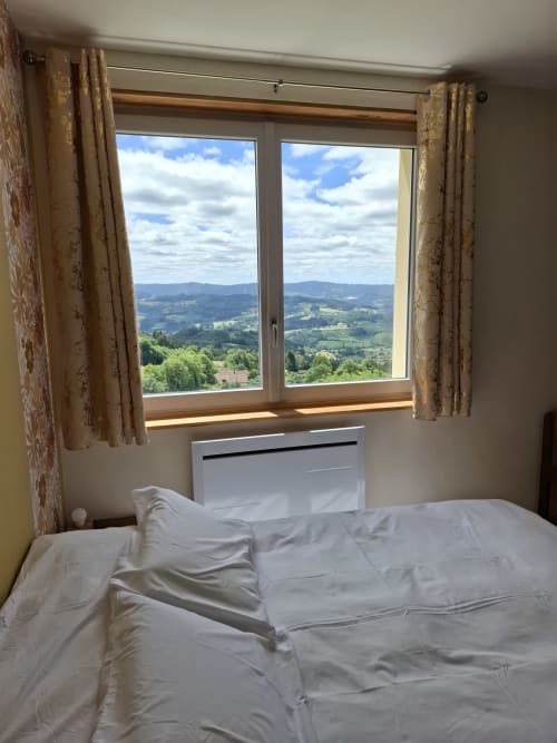 Chambre Passiflore bedroom at La Maison de Dun B&B with panoramic mountain view and golden curtains