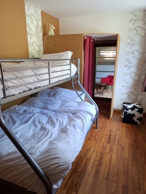 OAK Familial room at La Maison de Dun BnB in Saint Racho with metal bunk beds, wooden floor, and garden view