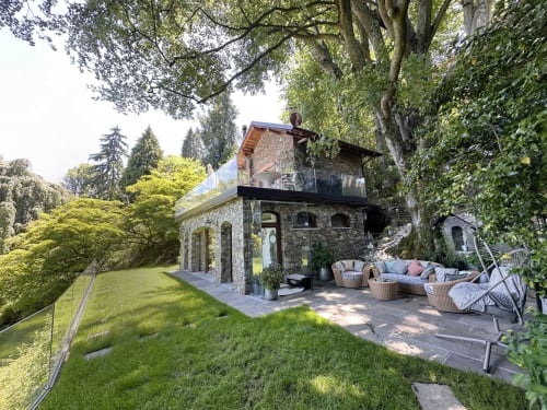 Luxury spa retreat terrace on Lake Maggiore with stone pavilion, seating areas, and lush gardens in Stresa