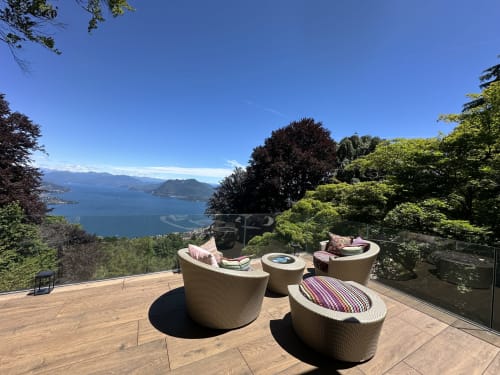 Luxury spa terrace with woven seating overlooking Lake Maggiore, Stresa, Italy