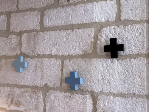 Drei farbenfrohe Pluszeichen auf weißer Backsteinmauer des Hôtel La Suite in Villeneuve-lès-Avignon