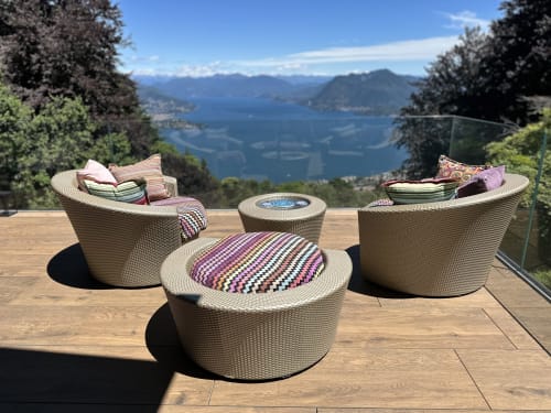 Woven outdoor furniture on lakeside terrace overlooking Lake Maggiore at luxury spa retreat in Stresa, Italy
