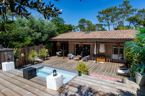 Villa Biscouette à La Loge Du Bassin à Lège Cap Ferret : terrasse en bois avec piscine chauffée, transats et villa moderne