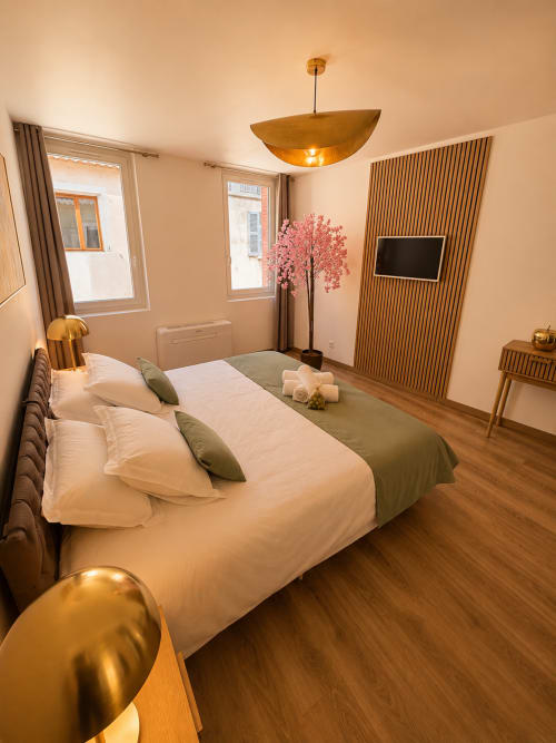 Spacious studio apartment at Le Clos Androne in Sisteron with modern furnishings, wooden flooring, and city views