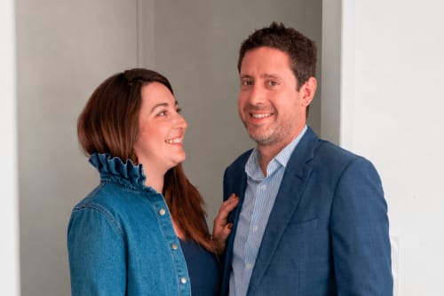 Two smiling professionals at ARLOÉ hotel in La Rochelle posing together in a modern interior setting