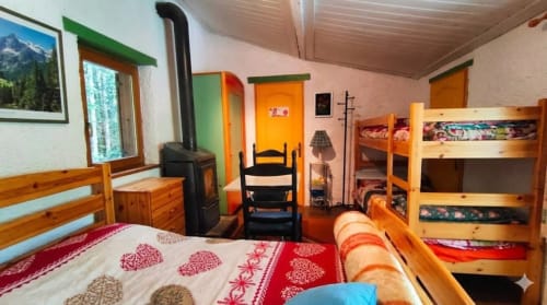 Chambre Marie-Ange at Le Portel des Arnaud: cozy bedroom with wooden furniture, bunk beds, and rustic Alpine décor in